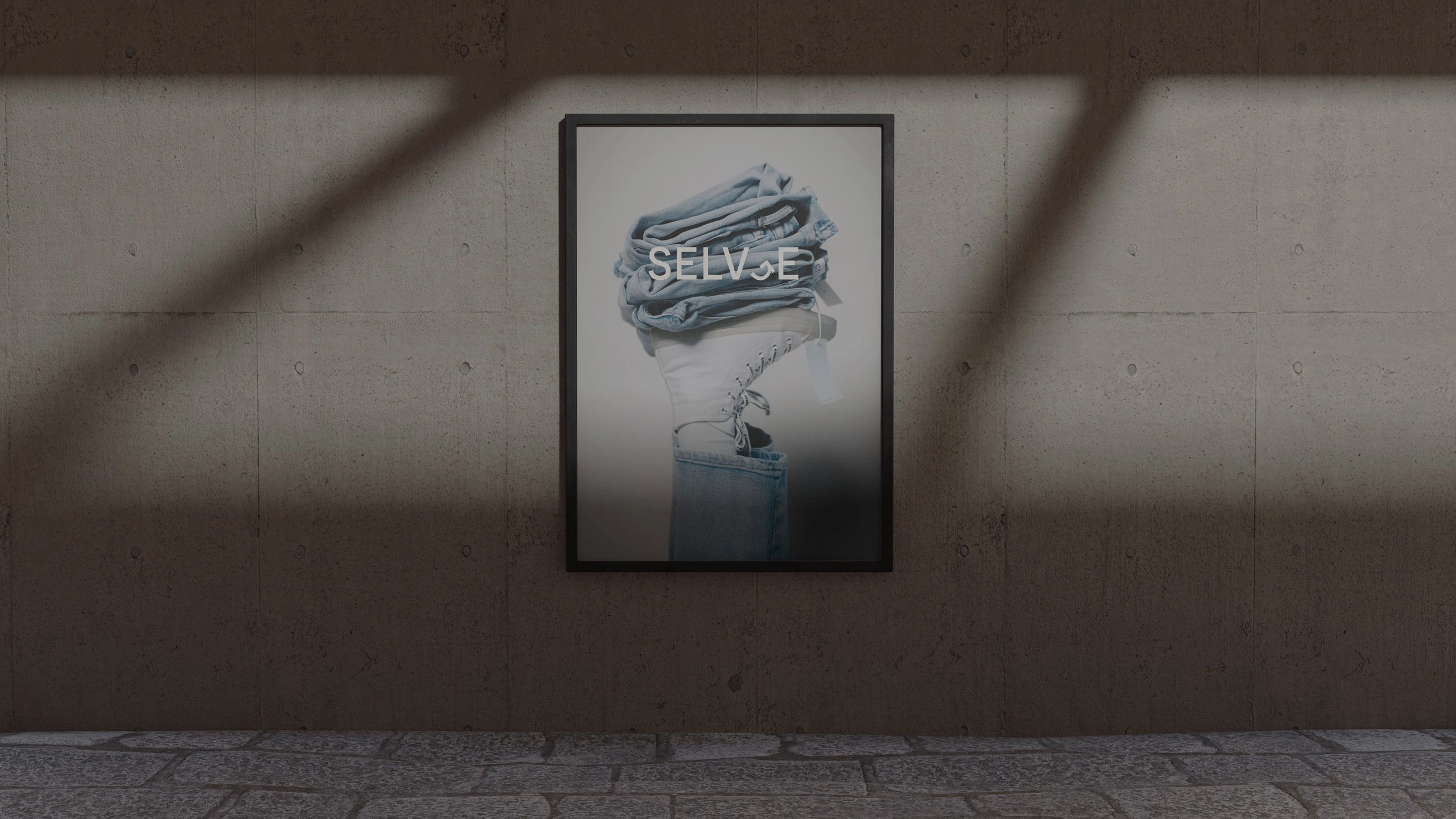 Framed poster of folded jeans and white boots with the word 'SELVJE'.
