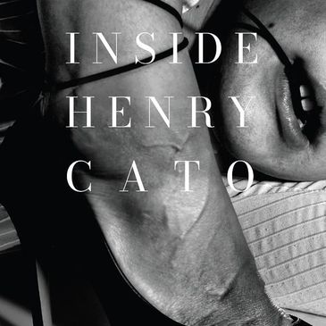 Black and white close-up of a muscular arm with the text 'INSIDE HENRY CATO'.