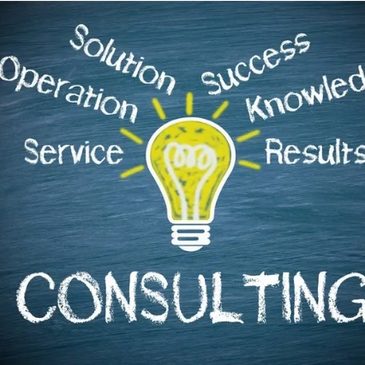 Lightbulb with consulting-related words on a chalkboard background.