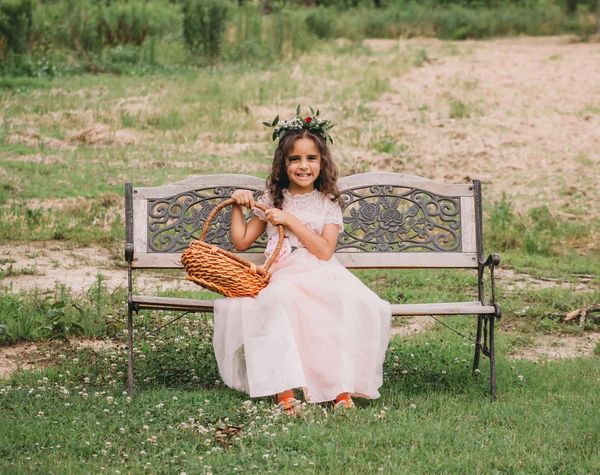 Flower girl on bench.