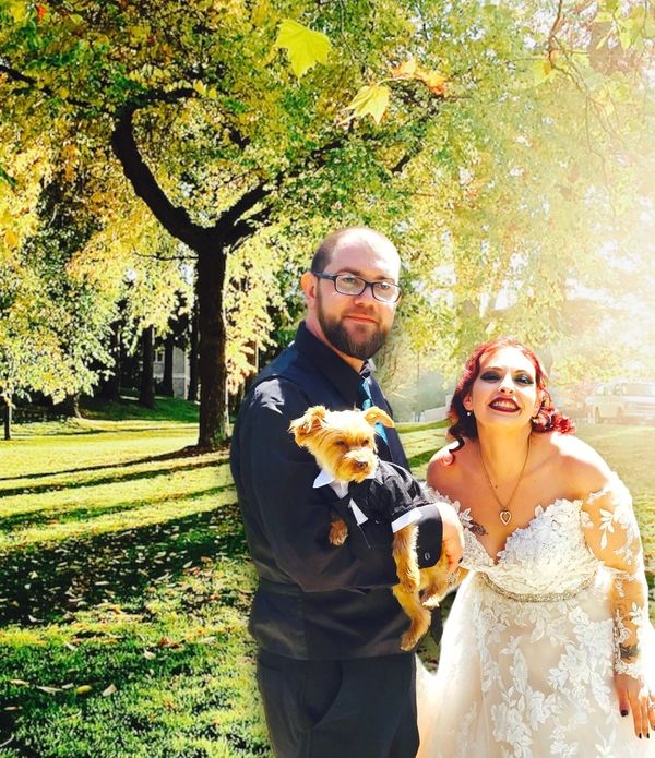 Bride in wedding dress and groom with fur baby