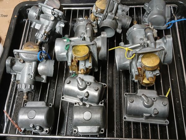 Selection of Suzuki motorbike carburettors after ultrasonic cleaning.