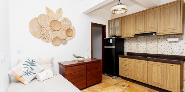 Cozy kitchen with wooden cabinets and decorative wall baskets.