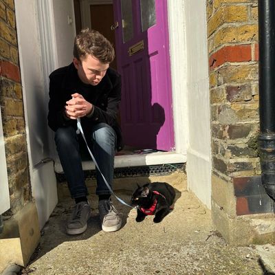 Daniel Shaw holding a cat on a lead