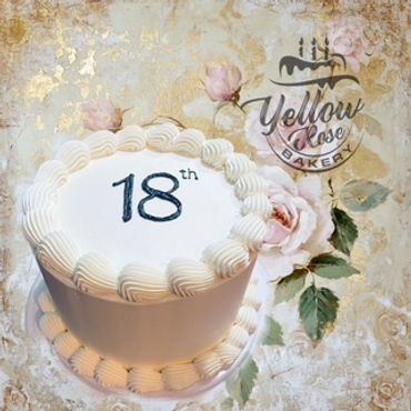 Elegant white cake celebrating an 18th birthday with floral background.