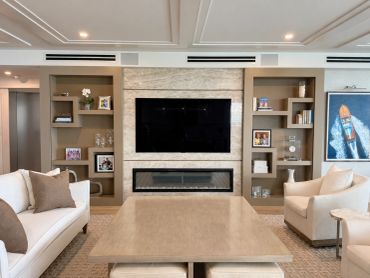 Modern living room with a TV and fireplace.