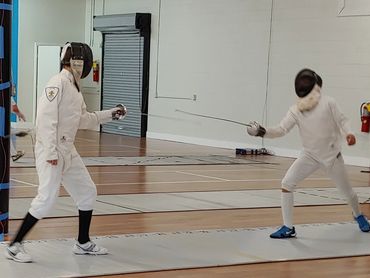 two male fencers in a bout
