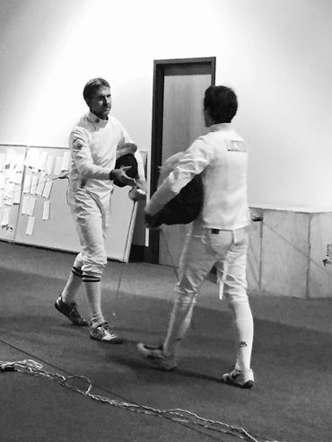 veteran fencers shaking hands after bout