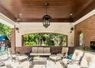 Back porch with stained wood ceiling and outdoor kitchen