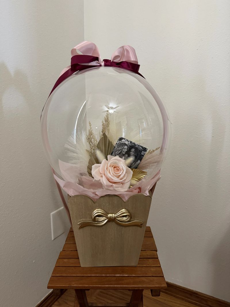 Balloon gift for bridal party with picture and florals inside a clear balloon.