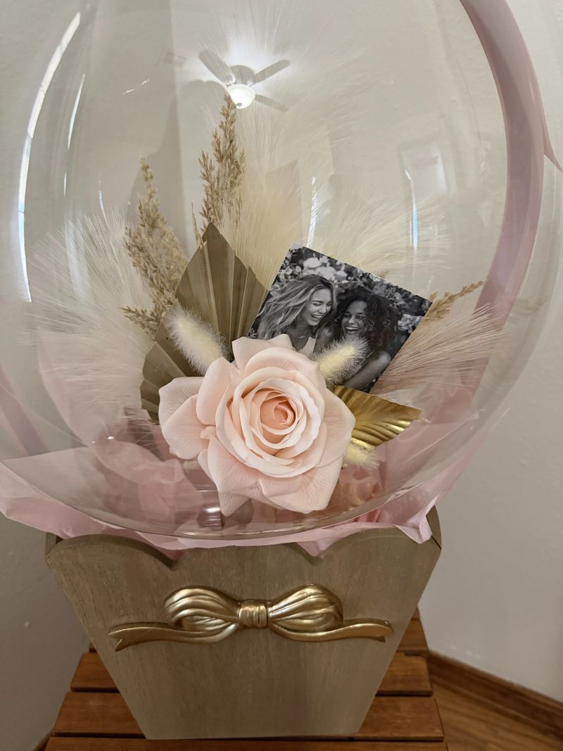 Balloon gift for bridal party with picture and florals inside a clear balloon.