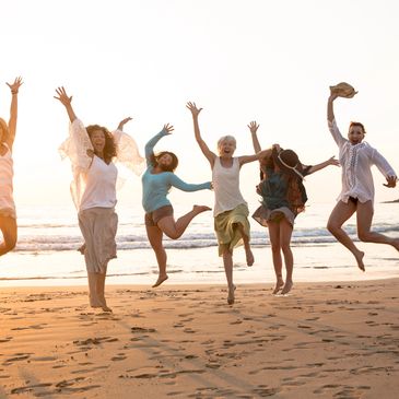 women jumping for joy at beach, SHE photography