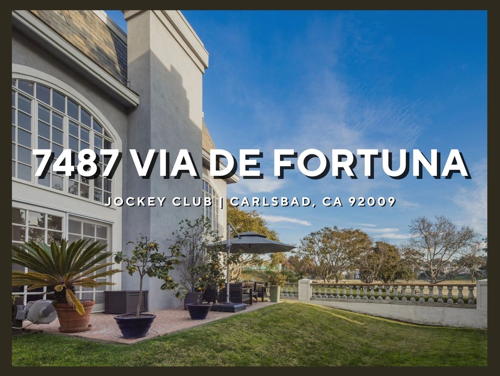 Elegant patio area of a home at 7487 Via De Fortuna, Carlsbad, CA with garden and clear sky.