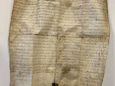 Old handwritten document with stains and creases.