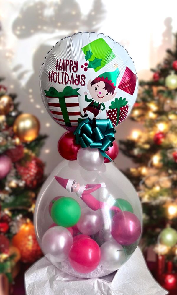 Festive balloon decoration with an elf and holiday greetings.