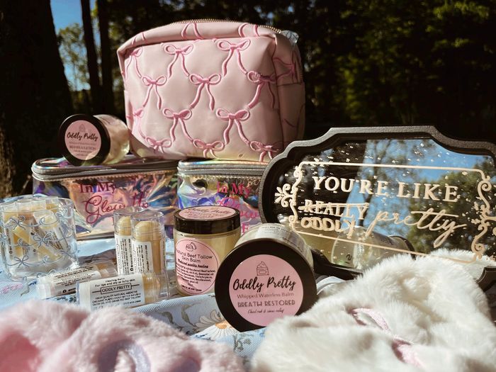 Beauty balm products with a pink cosmetic bag and a decorative mirror.