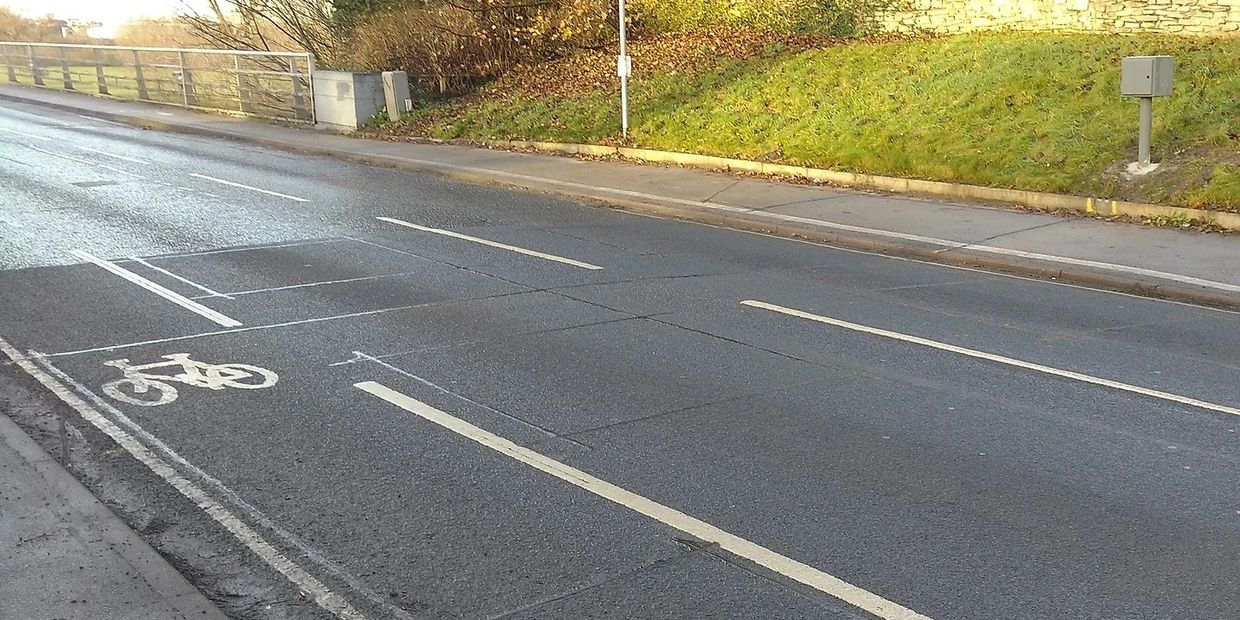 Photograph of classification loops on road and bicycle loops on foot path with a solar ped cabinet