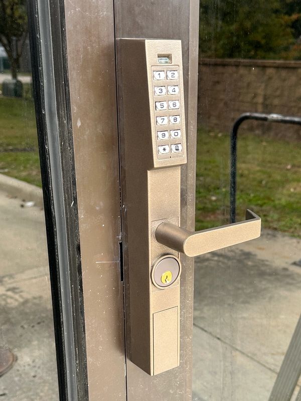 Commercial digital lock on a narrow stile storefront door