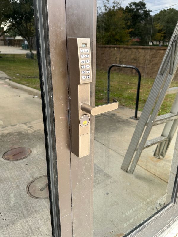 Commercial digital lock on a narrow stile storefront door