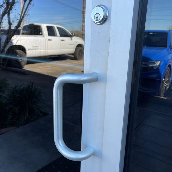 Pull handle for a glass storefront door in aluminum finish