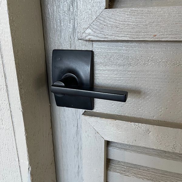 Modern design black door lever on a garage door