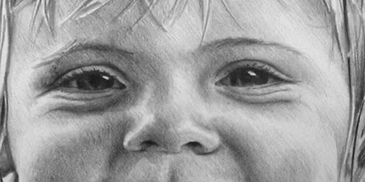 Close-up pencil sketch of a child's smiling face focusing on eyes and nose.