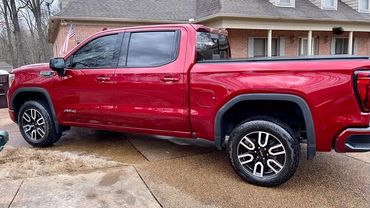 Red Large truck in driveway 