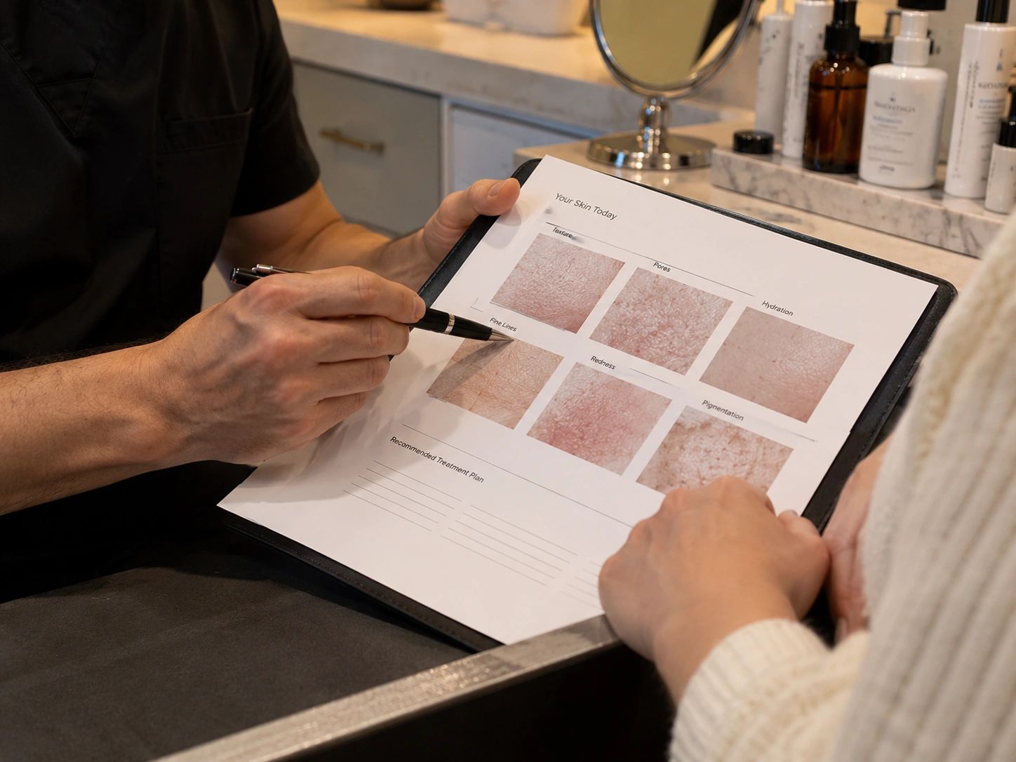 Person reviewing a skin analysis report with a client.