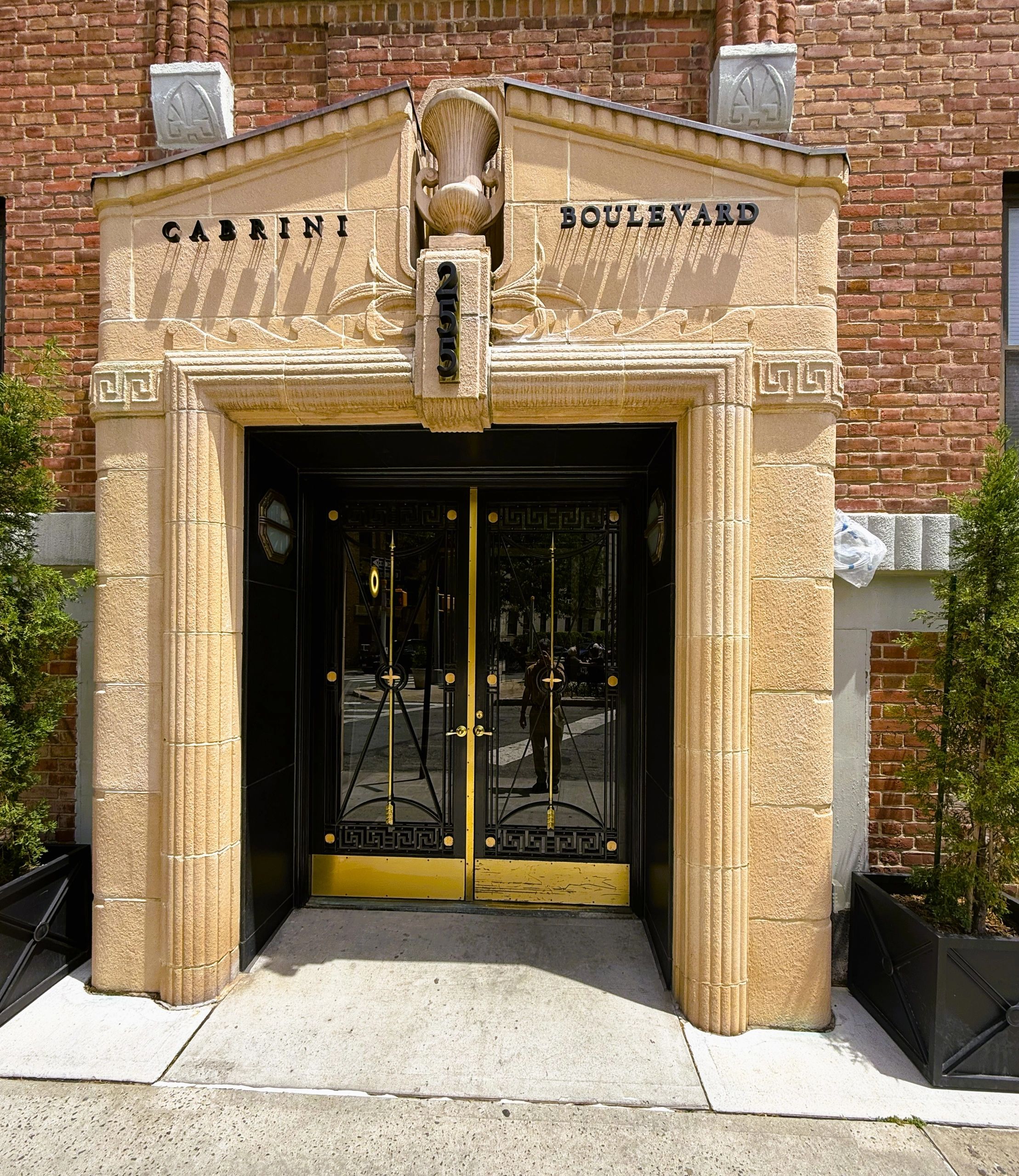 Entrance to Cabrini Boulevard with ornate doors and stonework.