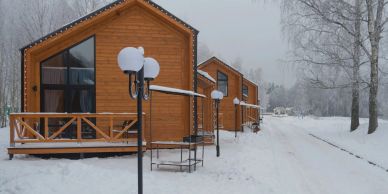 Wooden cabins in a snowy winter setting.