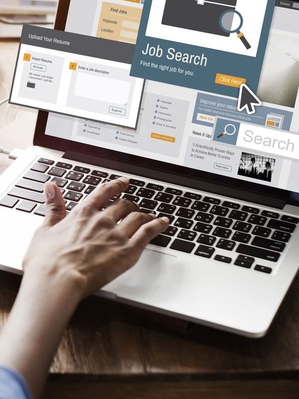Person using laptop for an online job search and resume upload.