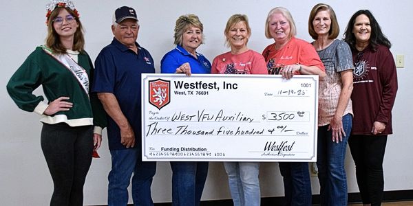 Group holding a large check for $3,500.