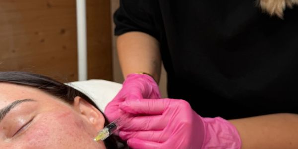 Person receiving a cosmetic facial injection.