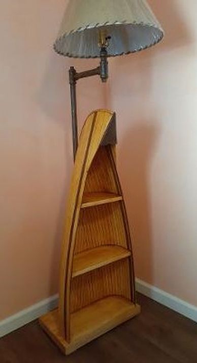 This ceder strip canoe lamp is hand constructed and has 3 shelves. The lamp sits on a live edge slab
