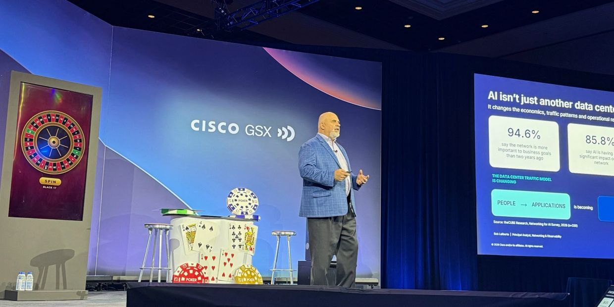 Man presenting at Cisco GSX conference with poker-themed decor.