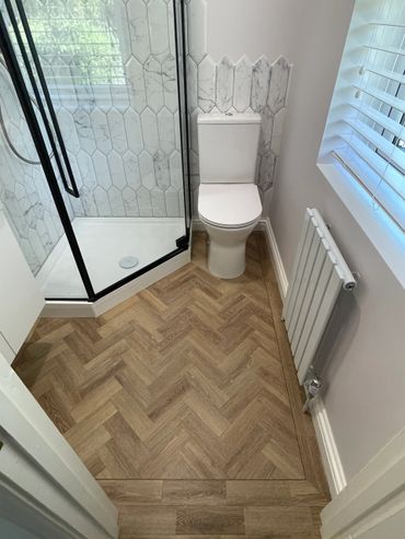 Modern bathroom with herringbone flooring 