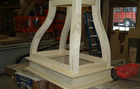 Custom wood range hood with curved panels for painted kitchen cabinets. Eureka Montana