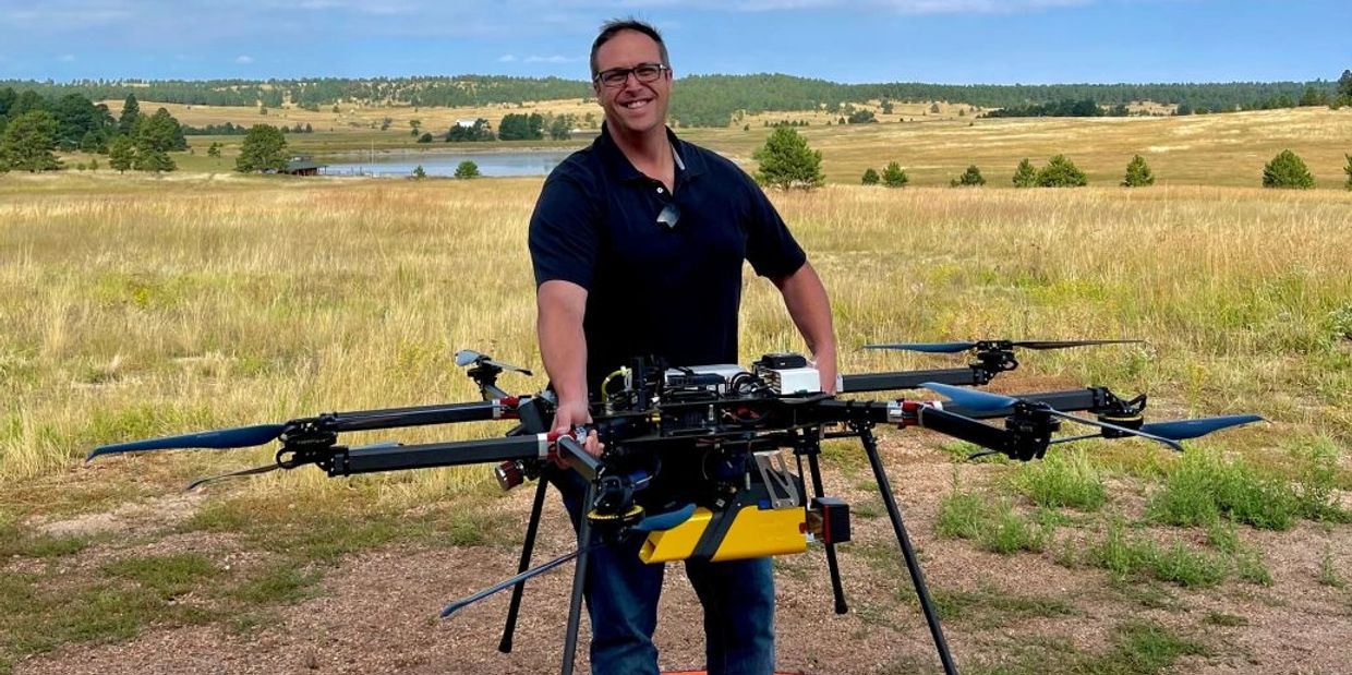 Jason holding a SkyFront Perimeter-8 Hydrib Heavy-Lift drone with a YellowScan LiDAR payload
