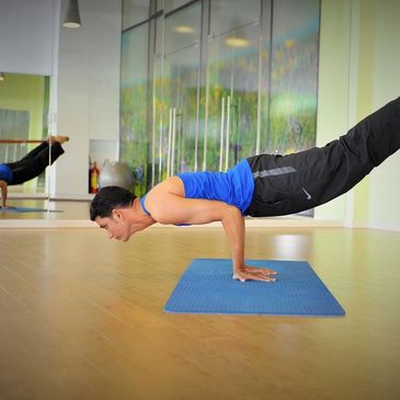 Sardar demos Peacock pose to an online yoga audience.