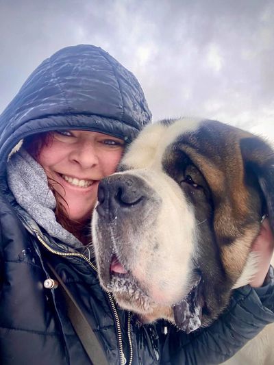 photographer in snow with a saint bernard dog