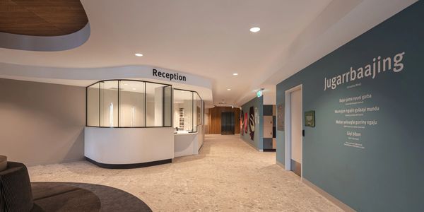 Modern reception area with curved design and blue accent wall.