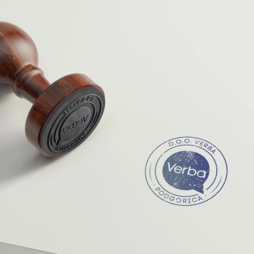 Wooden stamp with blue ink imprint on paper.