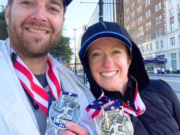 Running Awards and Apparel Race Consultant, Kate Boughner, with her husband and their race medals.