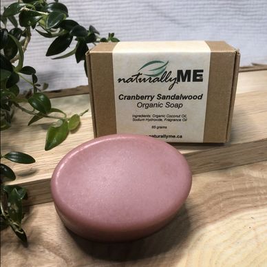 NaturallyME organic amber velvet soap with flowers on wooden surface.