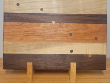 Whimsical cutting board with dowels forming the Big Dipper. Made with Maryland-sourced hardwoods mea