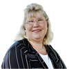 Marlo Nixon, Owner of Valley Real Estate. She is a woman, with blond hair and a black blazer with ve