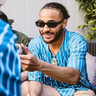 Man smiling and gesturing during a conversation