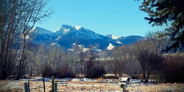 Winter mountain scene with farm fencing and Montana scenery.