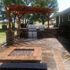 Paver patio installation with gas fire pit, two piece BBQ grill, and pergola.