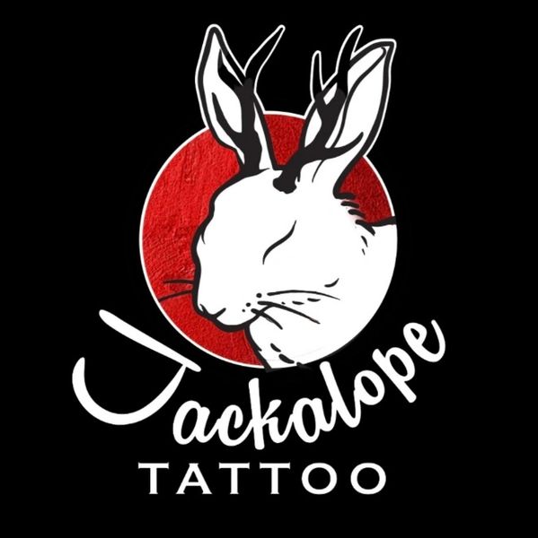 Logo of Jackalope Tattoo with a jackalope illustration.